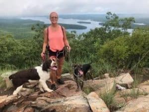 Tracy hiking with dogs in training